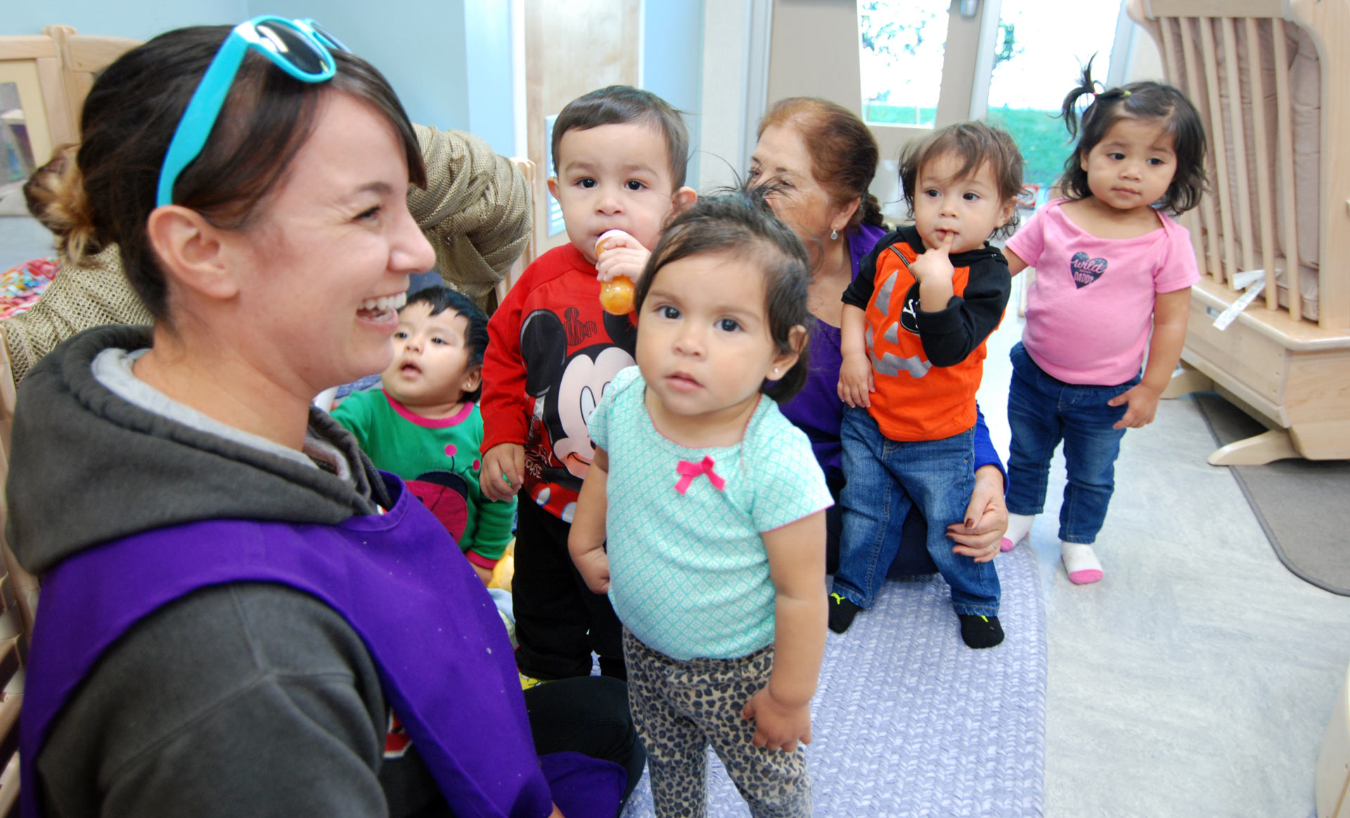 Teacher smiling with kids in room