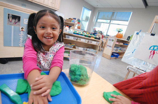 A smiling kid inside a classroom